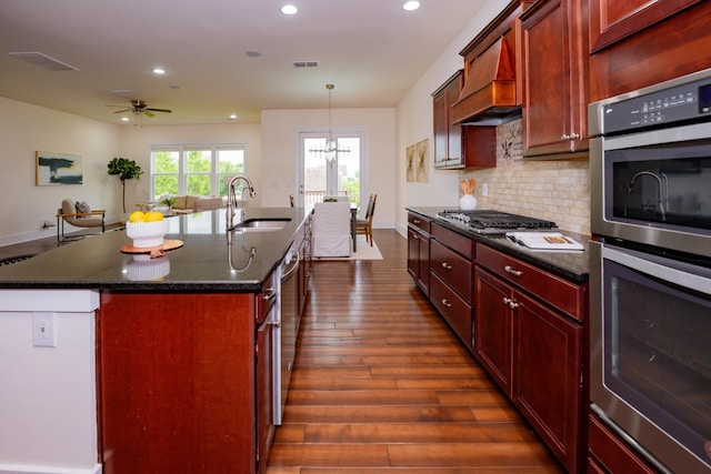 1820 Lanceford Ct, Franklin, TN 37067 - kitchen featuring stainless steel appliances, a sink, dark brown cabinets, recessed lighting, and dark wood-type flooring