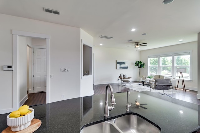 1820 Lanceford Ct, Franklin, TN 37067 - kitchen with a sink, ceiling fan, wood finished floors, dark stone countertops, and open floor plan