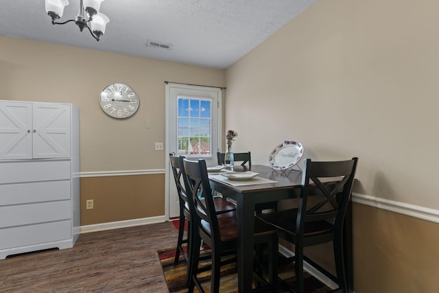 862 College St, Portland, TN 37148 - dining space featuring a chandelier, dark wood-type flooring, a textured ceiling, and baseboards