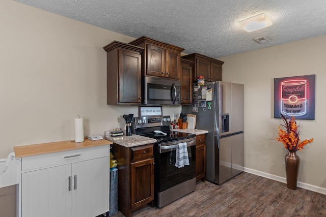 862 College St, Portland, TN 37148 - kitchen featuring appliances with stainless steel finishes, dark wood finished floors, dark brown cabinets, a textured ceiling, and baseboards