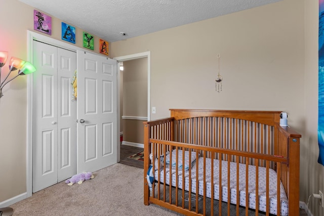 862 College St, Portland, TN 37148 - carpeted bedroom with a closet, a textured ceiling, a crib, and baseboards