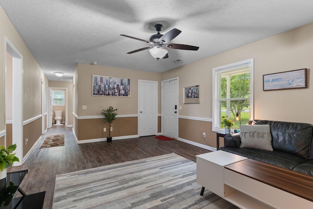 862 College St, Portland, TN 37148 - living room featuring wood finished floors, a ceiling fan, a textured ceiling, and baseboards