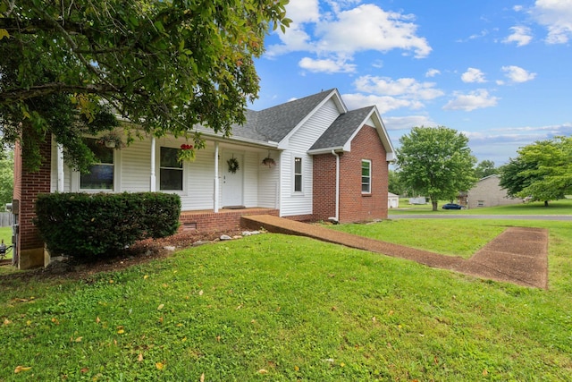 862 College St, Portland, TN 37148 - view of front facade featuring covered porch, a front yard, a shingled roof, and brick siding