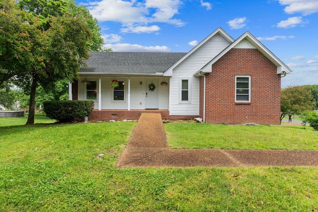 862 College St, Portland, TN 37148 - view of front of house featuring a front lawn, a porch, roof with shingles, and brick siding