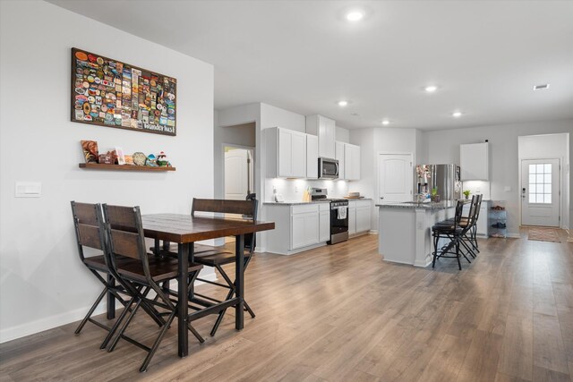 2405 Quinn Dr, White House, TN 37188 - dining area with baseboards, light wood-type flooring, and recessed lighting