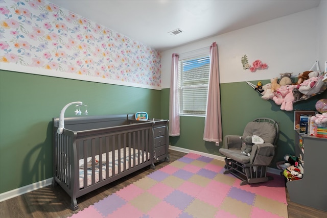 2405 Quinn Dr, White House, TN 37188 - bedroom with wood finished floors, a nursery area, and baseboards