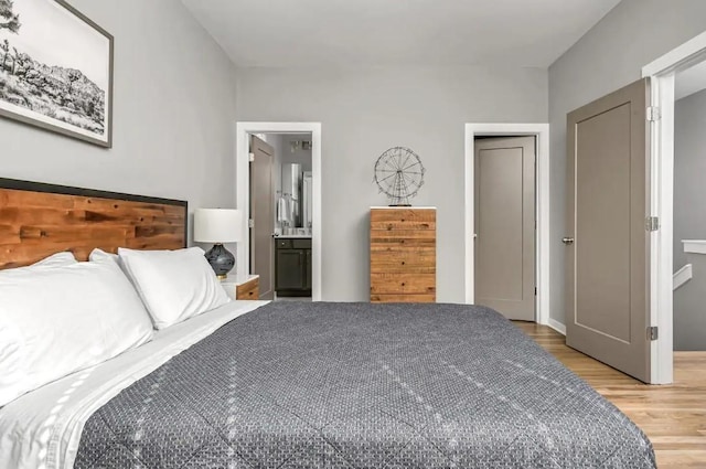2120 Herman St Unit 9, Nashville, TN 37208 - bedroom featuring light wood-style floors and ensuite bathroom