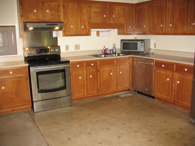 6225 Mount View Rd, Antioch, TN 37013 - kitchen featuring appliances with stainless steel finishes, under cabinet range hood, a sink, brown cabinets, and light countertops