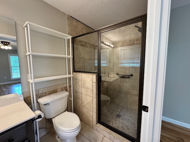 410 Sunset Ln, Monterey, TN 38574 - bathroom featuring a textured ceiling, a shower stall, toilet, vanity, and a ceiling fan