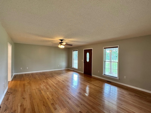 410 Sunset Ln, Monterey, TN 38574 - unfurnished living room with a textured ceiling, wood finished floors, a ceiling fan, and baseboards
