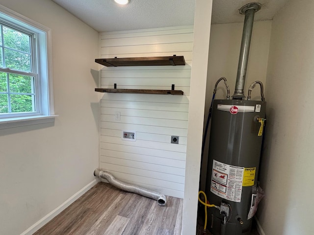 410 Sunset Ln, Monterey, TN 38574 - washroom featuring gas water heater, wood finished floors, hookup for an electric dryer, baseboards, and a textured ceiling