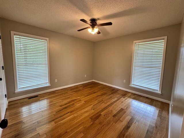 410 Sunset Ln, Monterey, TN 38574 - empty room featuring hardwood / wood-style flooring, ceiling fan, a textured ceiling, baseboards, and plenty of natural light