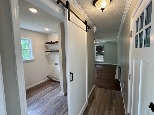 410 Sunset Ln, Monterey, TN 38574 - hallway featuring a barn door, a textured ceiling, ornamental molding, dark wood finished floors, and baseboards