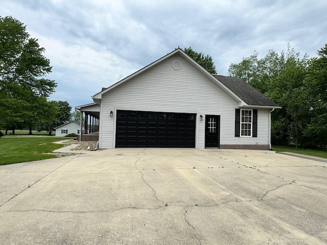 410 Sunset Ln, Monterey, TN 38574 - view of side of property featuring an attached garage, driveway, a lawn, and a shingled roof