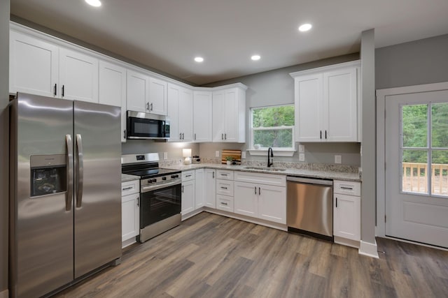 85 Truform Way, Dickson, TN 37055 - kitchen with appliances with stainless steel finishes, a sink, dark wood-style floors, recessed lighting, and white cabinets