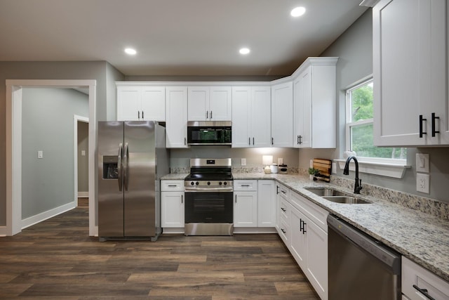 85 Truform Way, Dickson, TN 37055 - kitchen with stainless steel appliances, a sink, white cabinets, dark wood finished floors, and light stone counters