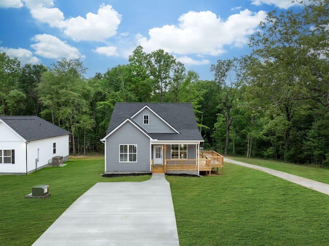 85 Truform Way, Dickson, TN 37055 - view of front facade featuring central AC, covered porch, a front yard, concrete driveway, and a shingled roof
