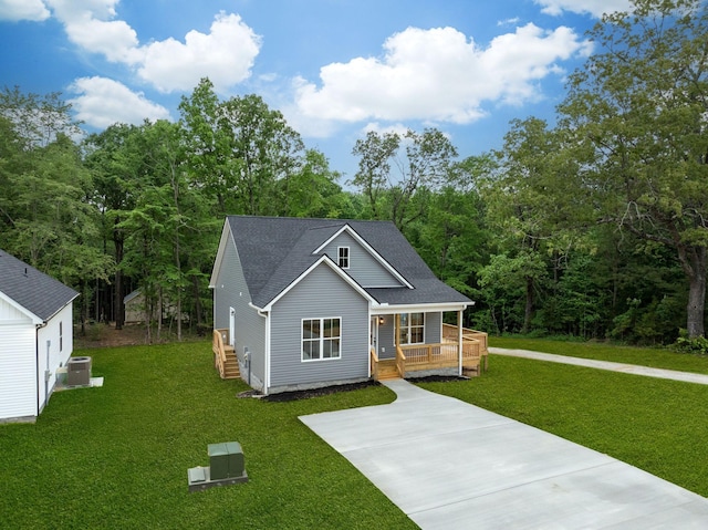 85 Truform Way, Dickson, TN 37055 - view of front facade with covered porch, central AC, a front lawn, roof with shingles, and driveway