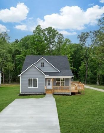 85 Truform Way, Dickson, TN 37055 - back of house featuring a lawn, a porch, and a forest view