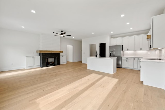 811 Oconner St, Smithville, TN 37166 - kitchen featuring stainless steel fridge with ice dispenser, a ceiling fan, tasteful backsplash, white cabinets, and light wood-style floors