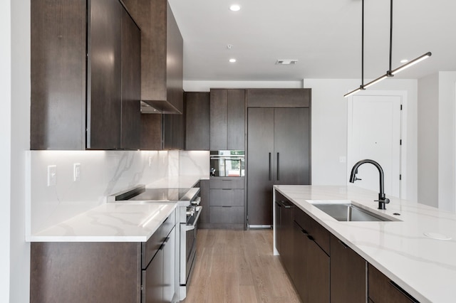 321 31st Ave N Unit B8 A, Nashville, TN 37203 - kitchen with stainless steel appliances, modern cabinets, dark brown cabinetry, and recessed lighting