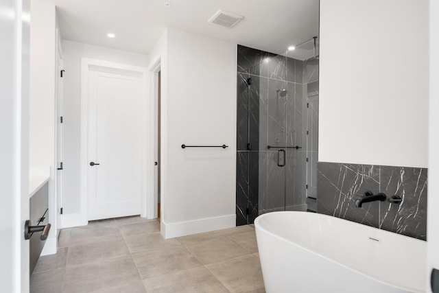 321 31st Ave N Unit B8 A, Nashville, TN 37203 - bathroom featuring a freestanding tub, a marble finish shower, recessed lighting, and vanity