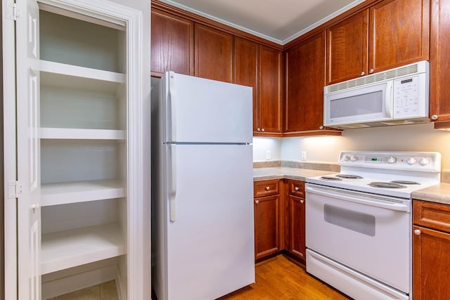 4316 Summercrest Blvd Unit 512, Antioch, TN 37013 - kitchen featuring white appliances, light countertops, light wood-type flooring, and brown cabinetry
