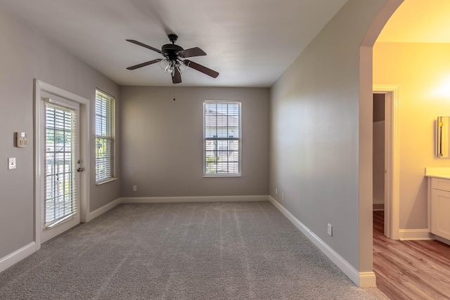 4316 Summercrest Blvd Unit 512, Antioch, TN 37013 - empty room featuring arched walkways, ceiling fan, baseboards, and light colored carpet