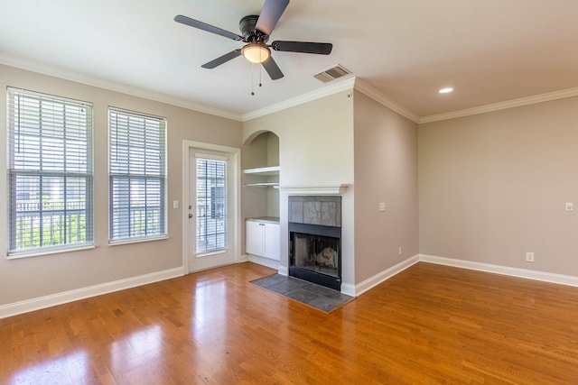 4316 Summercrest Blvd Unit 512, Antioch, TN 37013 - unfurnished living room featuring built in features, a tiled fireplace, wood finished floors, baseboards, and ornamental molding