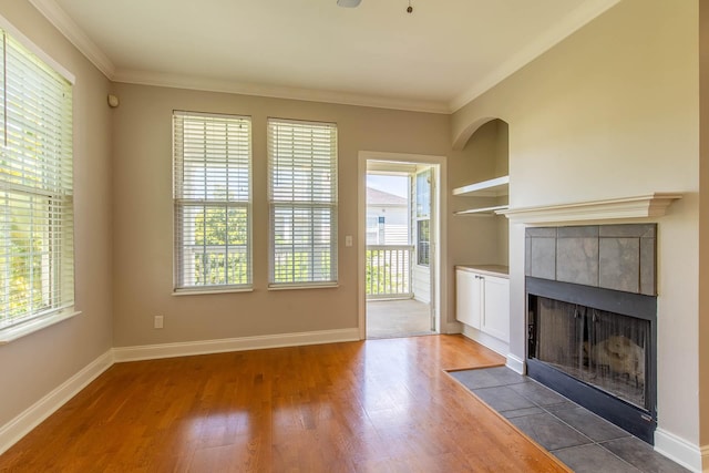 4316 Summercrest Blvd Unit 512, Antioch, TN 37013 - unfurnished living room featuring ornamental molding, a fireplace, wood finished floors, and baseboards