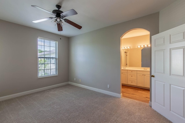 4316 Summercrest Blvd Unit 512, Antioch, TN 37013 - empty room with light colored carpet, arched walkways, a ceiling fan, and baseboards
