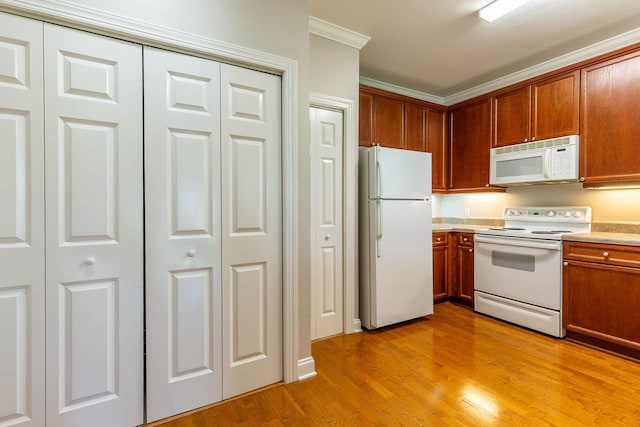 4316 Summercrest Blvd Unit 512, Antioch, TN 37013 - kitchen with white appliances, light countertops, light wood-type flooring, ornamental molding, and brown cabinets