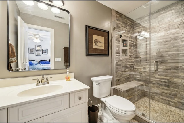 5122 Stonewood Dr, Smyrna, TN 37167 - bathroom with connected bathroom, a shower stall, toilet, vanity, and ceiling fan