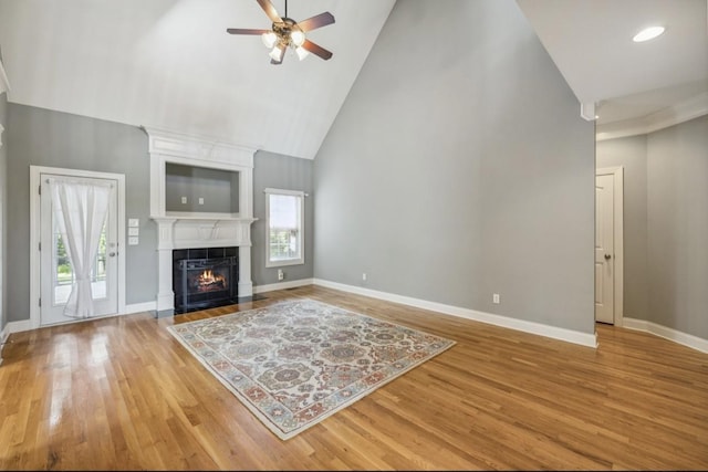 5122 Stonewood Dr, Smyrna, TN 37167 - living room featuring high vaulted ceiling, ceiling fan, wood finished floors, baseboards, and a fireplace with flush hearth