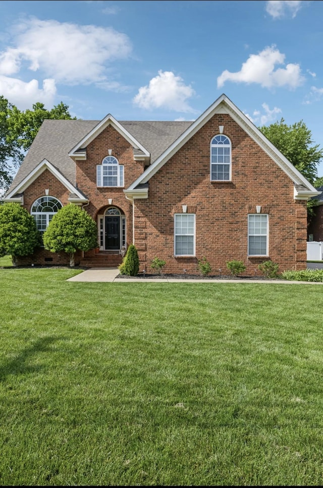 5122 Stonewood Dr, Smyrna, TN 37167 - traditional-style home featuring brick siding, a front lawn, and roof with shingles