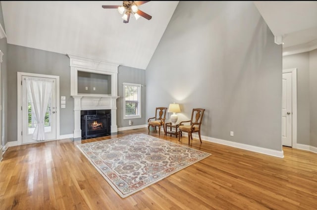 5122 Stonewood Dr, Smyrna, TN 37167 - sitting room with high vaulted ceiling, ceiling fan, light wood-style flooring, a large fireplace, and baseboards