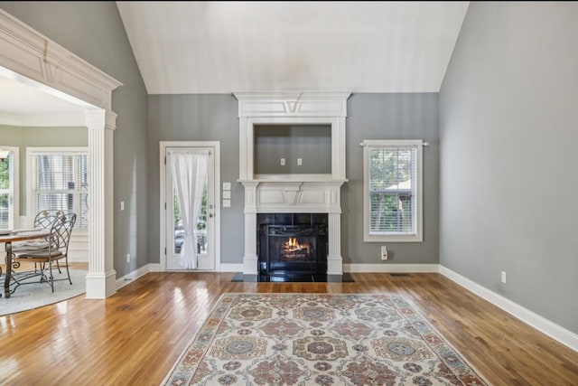 5122 Stonewood Dr, Smyrna, TN 37167 - living area with wood finished floors, high vaulted ceiling, a lit fireplace, and baseboards