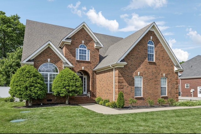 5122 Stonewood Dr, Smyrna, TN 37167 - traditional home with brick siding, a front lawn, and roof with shingles