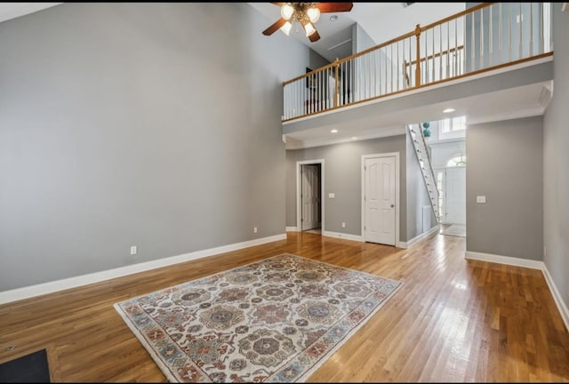 5122 Stonewood Dr, Smyrna, TN 37167 - living area with a ceiling fan, stairs, baseboards, a high ceiling, and wood finished floors