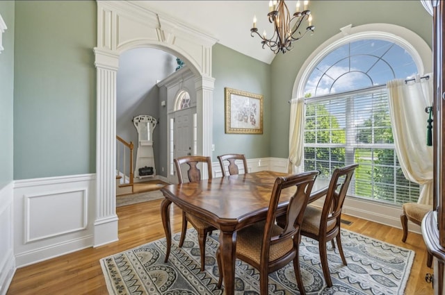 5122 Stonewood Dr, Smyrna, TN 37167 - dining room with healthy amount of natural light, wainscoting, a chandelier, arched walkways, and wood finished floors
