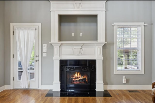 5122 Stonewood Dr, Smyrna, TN 37167 - detailed view of a tile fireplace, wood finished floors, and baseboards