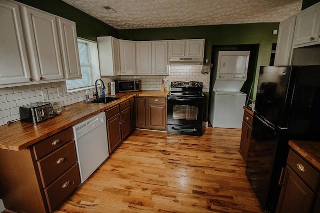 800 Riverside Dr, Columbia, TN 38401 - kitchen featuring black appliances, stacked washer and clothes dryer, butcher block counters, a sink, and under cabinet range hood