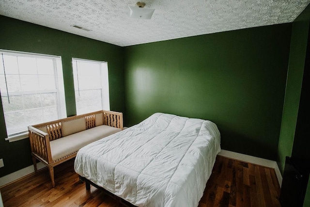 800 Riverside Dr, Columbia, TN 38401 - bedroom with wood finished floors, baseboards, and a textured ceiling