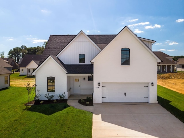 317 Galway Dr, Clarksville, TN 37042 - view of front of home with a garage, board and batten siding, a front yard, and concrete driveway