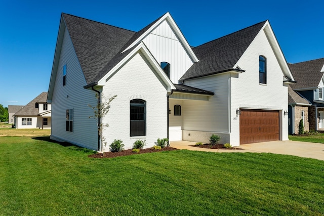 317 Galway Dr, Clarksville, TN 37042 - view of front of home featuring a garage, brick siding, a front lawn, driveway, and roof with shingles