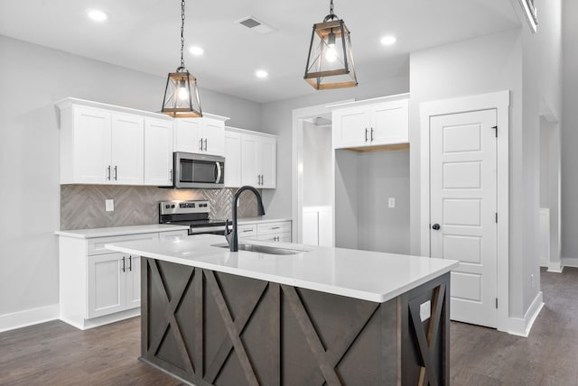 321 Galway Dr, Clarksville, TN 37042 - kitchen featuring stainless steel appliances, a sink, tasteful backsplash, dark wood-style floors, and recessed lighting