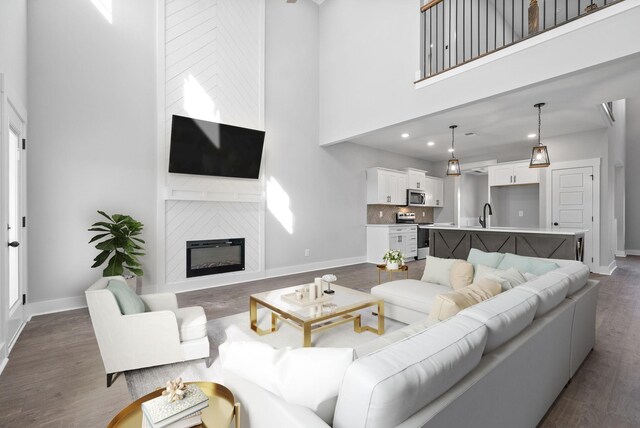 321 Galway Dr, Clarksville, TN 37042 - living area featuring a high ceiling, baseboards, dark wood-style floors, a large fireplace, and recessed lighting