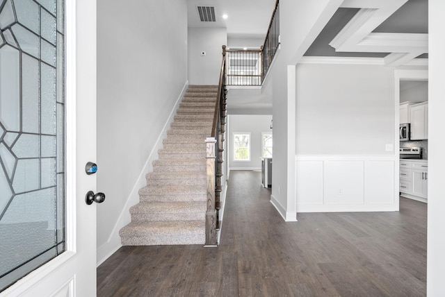 321 Galway Dr, Clarksville, TN 37042 - entryway featuring dark wood finished floors, stairway, ornamental molding, wainscoting, and a high ceiling