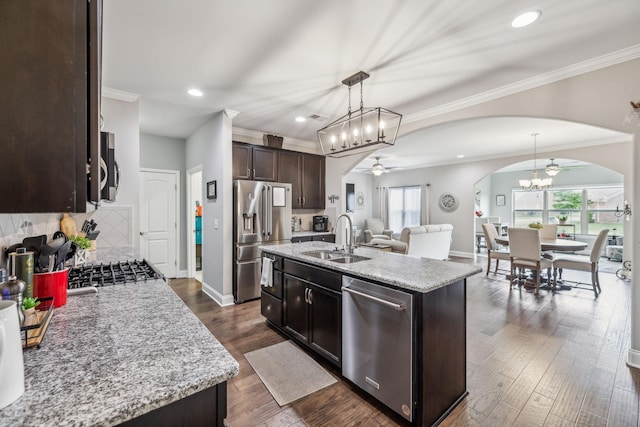1420 Whispering Oaks Dr, Lebanon, TN 37090 - kitchen with stainless steel appliances, arched walkways, ceiling fan, a sink, and dark brown cabinets