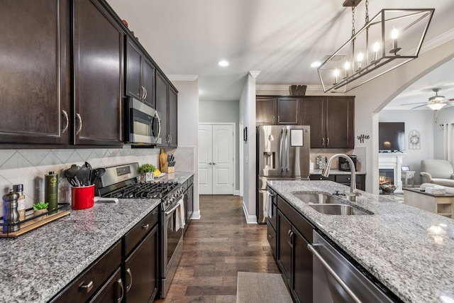 1420 Whispering Oaks Dr, Lebanon, TN 37090 - kitchen featuring appliances with stainless steel finishes, a sink, light stone countertops, open floor plan, and a ceiling fan